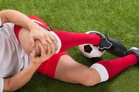 soccer player with knee pain waiting for physio